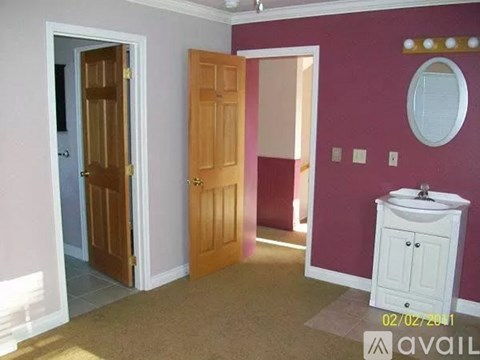 A bathroom with a sink and a mirror.