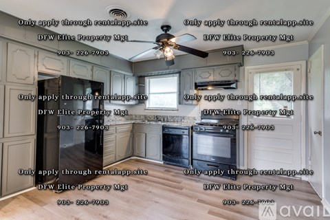 A kitchen with a large island and a ceiling fan.