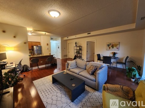 A living room with a grey couch and a coffee table.