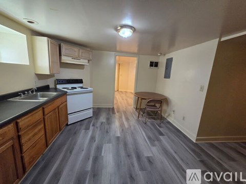 A kitchen with a table and chairs in the middle of the room.