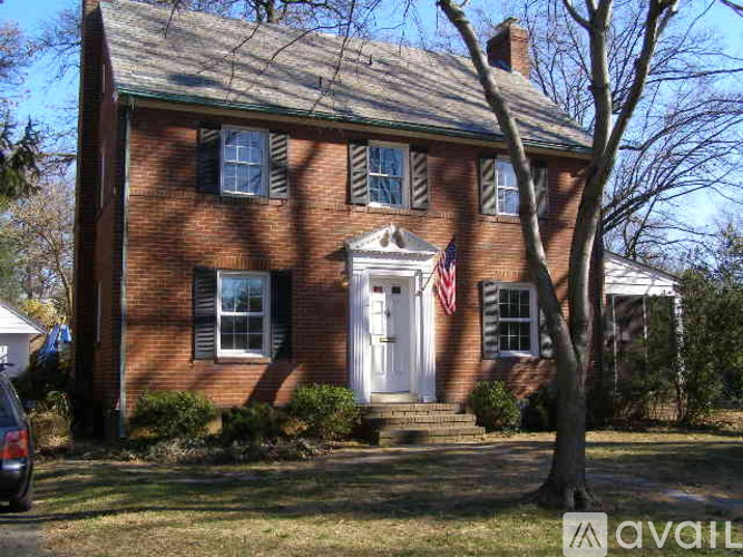 A house with a white door and an American flag on the front.