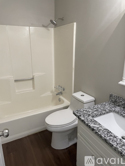 A bathroom with a toilet, sink, and bathtub.
