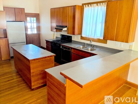 A kitchen with wooden cabinets and a white counter.