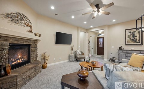 A living room with a fireplace and a television mounted on the wall.
