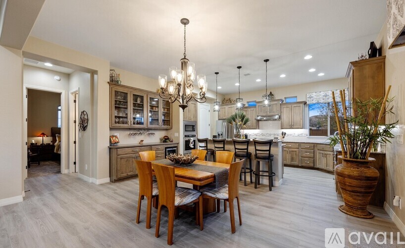A well-lit dining area with a wooden table and chairs.
