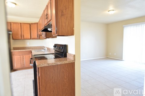 A kitchen with wooden cabinets and a black oven.