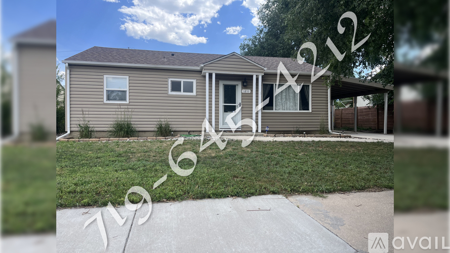 A house with a front yard and a driveway is for sale.