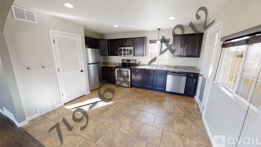 A kitchen with a tile floor and a number 719 on the floor.