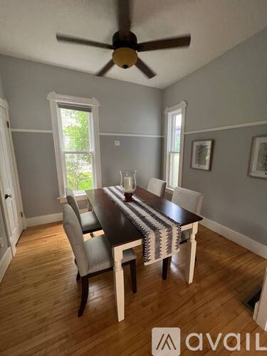 A dining room with a table and chairs.