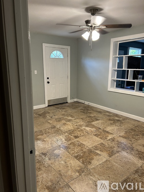 A room with a tiled floor and a ceiling fan.