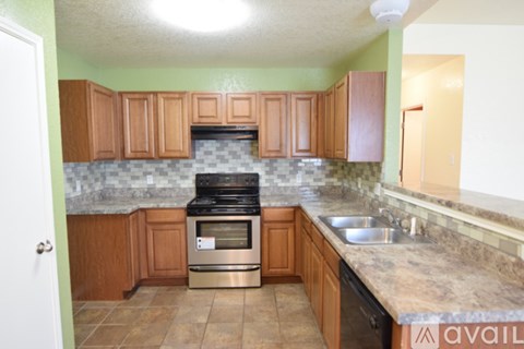 A kitchen with a stove and oven in the middle.