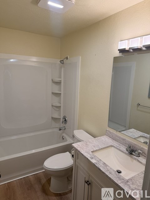 A bathroom with a toilet, sink, and bathtub.