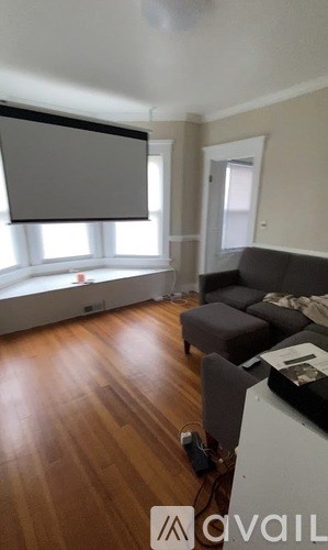 A living room with a couch and a table with a box on it.