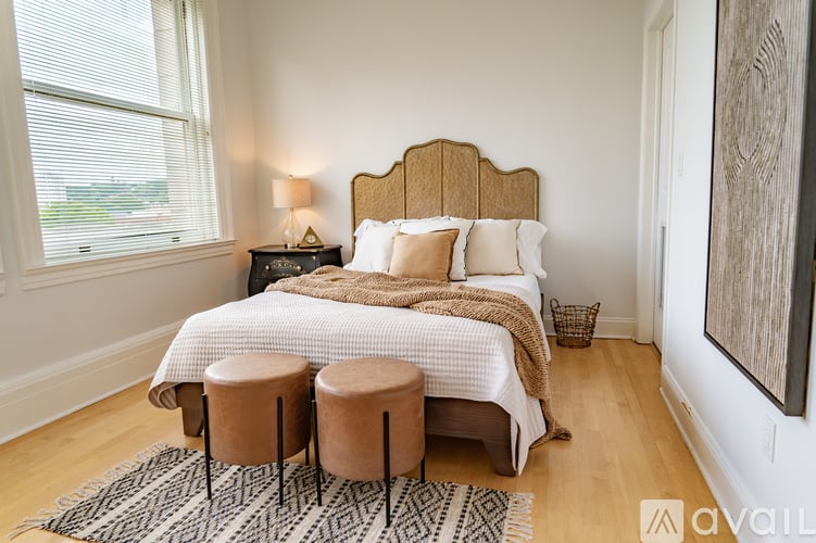 A bedroom with a large bed and a wooden headboard.
