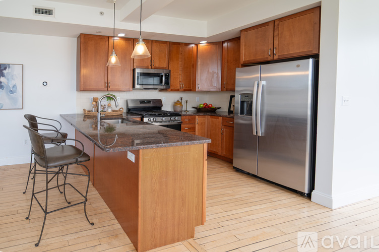 A kitchen with wooden cabinets and a granite countertop.