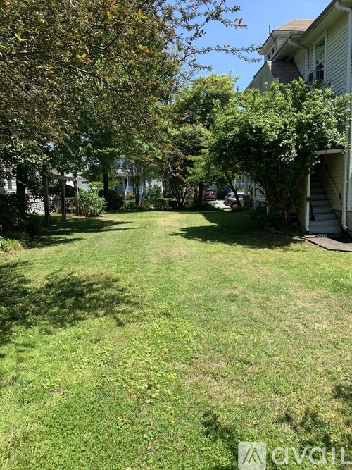 A backyard with a lawn and trees.