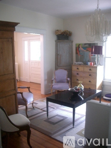 A living room with a black table and chairs.