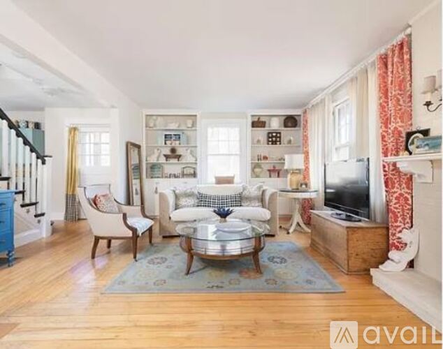 A living room with a coffee table in the middle.