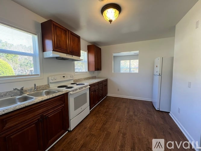 A kitchen with wooden cabinets and white appliances.