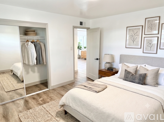 A bedroom with a large bed and a wardrobe.