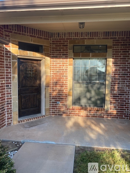 A brick house with a window and a door.
