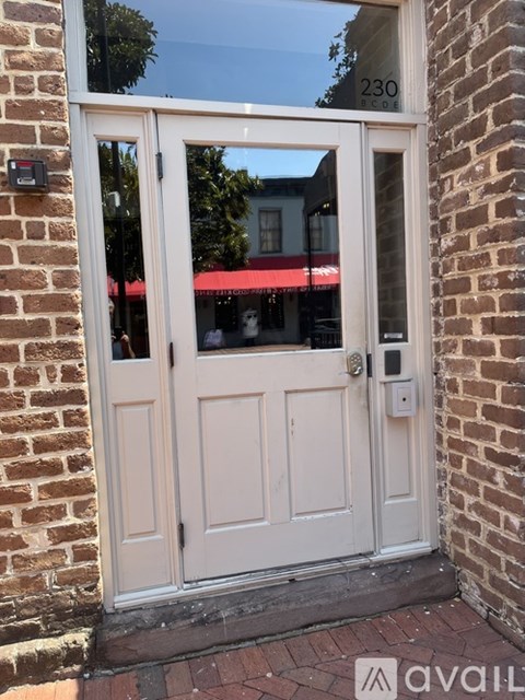 A white door with a glass window and a lock on the right side.