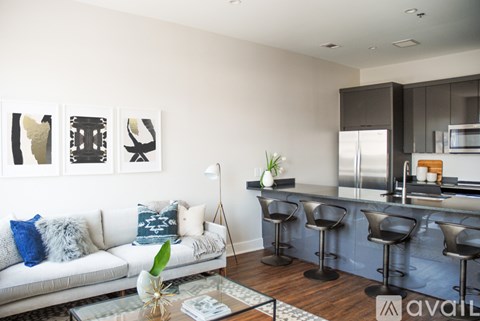 A living room with a white couch and a bar area.