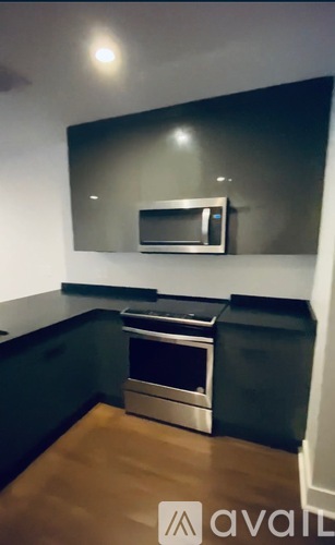 A kitchen with a stove and microwave built into the counter.