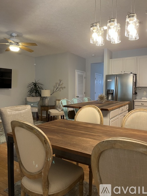 A dining room with a wooden table and chairs.