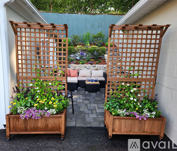 Two wooden planters with flowers in them are in the foreground.