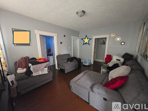 A living room with grey couches and a star decoration on the wall.