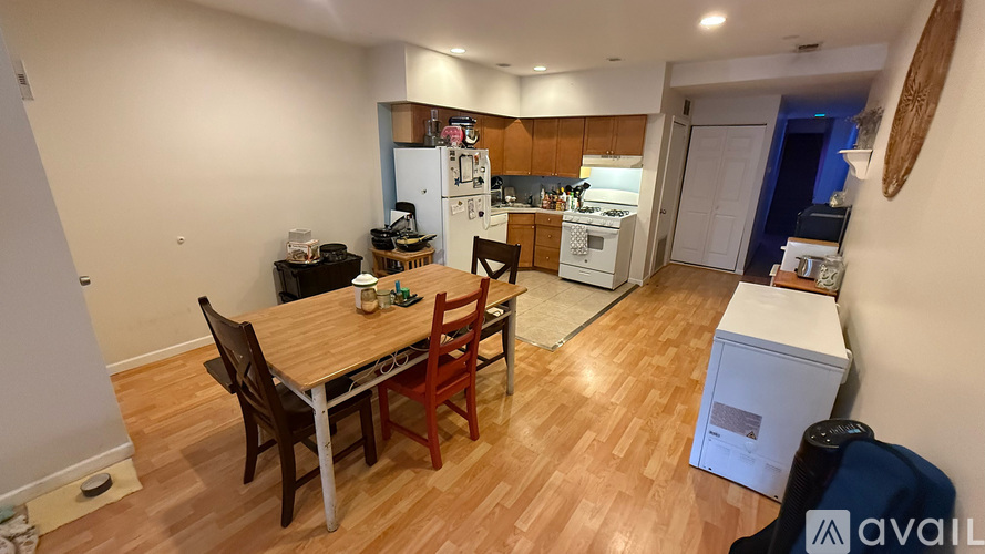 A kitchen with a table and chairs in the middle of the room.
