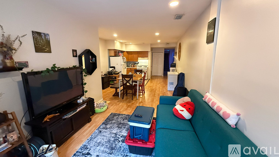 A living room with a green couch and a television.