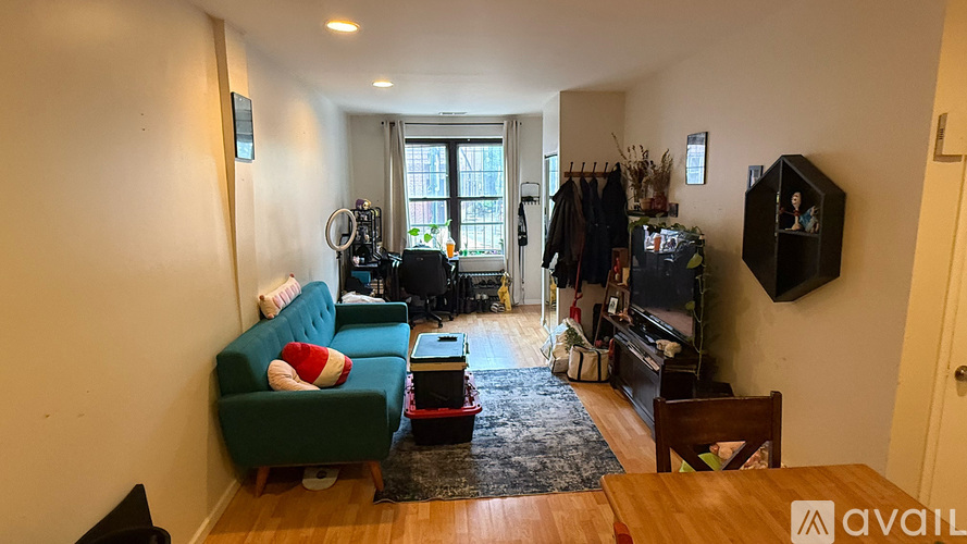 A living room with a green couch and a wooden table.