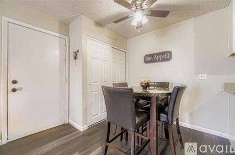 A dining room with a table set for two and a sign that says Bon Appetit.