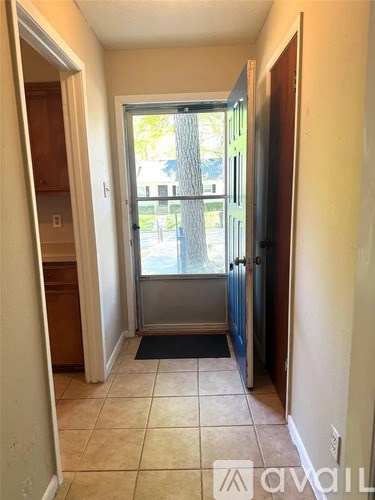 A hallway with a door leading to a balcony.