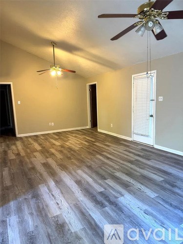 A room with a ceiling fan and a light hanging from the ceiling.