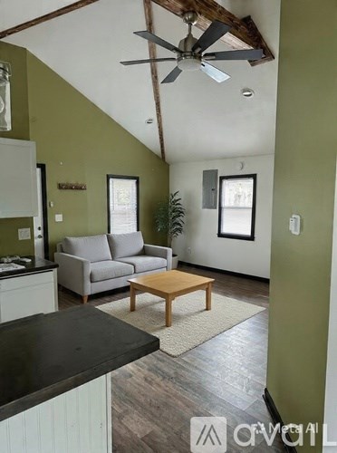 A living room with a grey couch and a wooden coffee table.