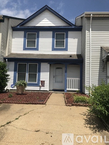A two-story house with a blue front door and white trim.