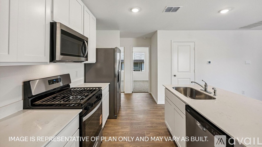 A kitchen with a black stove top oven and a black microwave above it.