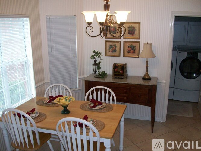 A dining room with a wooden table set for a meal.