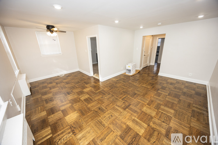 A room with wooden flooring and a ceiling fan.