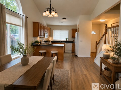 A modern kitchen with wooden cabinets and a dining table with chairs.