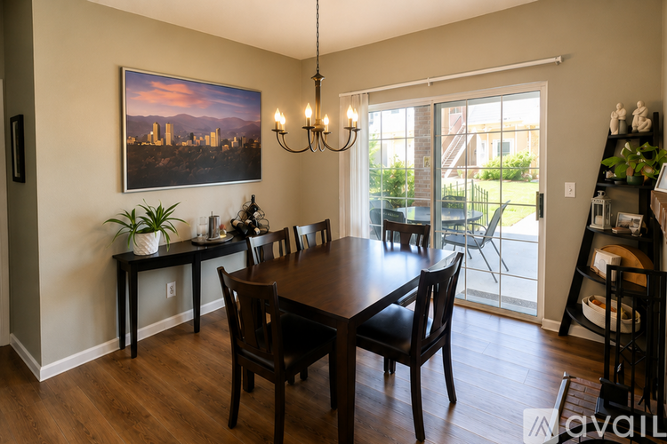 A dining room with a wooden table and chairs.