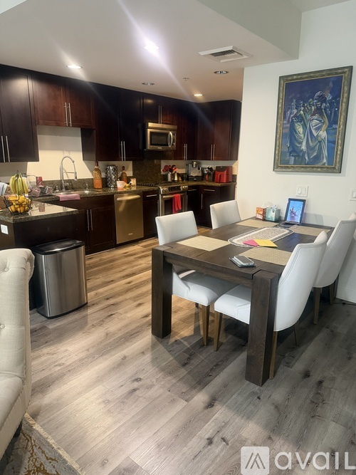 A kitchen with a dining table and chairs.