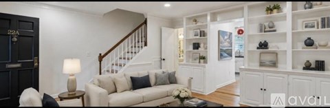 A living room with a white couch and a coffee table.
