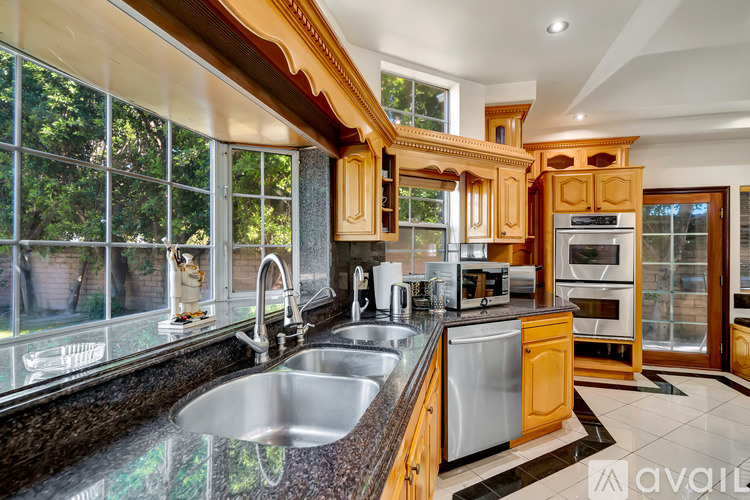 A kitchen with wooden cabinets and a large island.