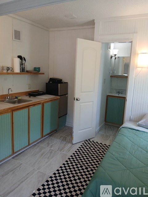 A room with a sink and a bed.