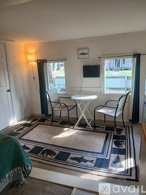 A room with a table and chairs in it.