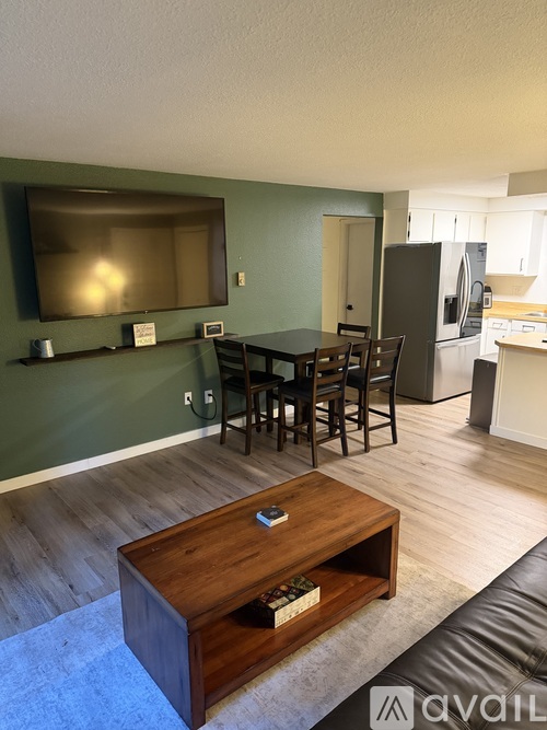 A living room with a wooden coffee table in the center.